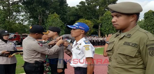 kapolres baubau mesangkan pita kepada petugas operasi ketupat