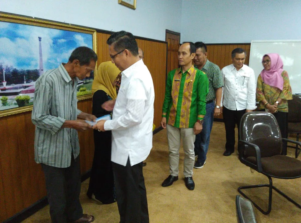Plt Walikota Kendari Sulkarnain, menyerahkan dana ganti rugi pada perwakilan warga Jalan Chairil Anwar